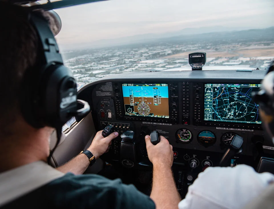 A man flying an airplane in the sky.